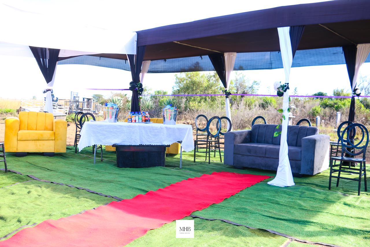 Graveside tent with lounge suites, red carpet aisle and refreshments table