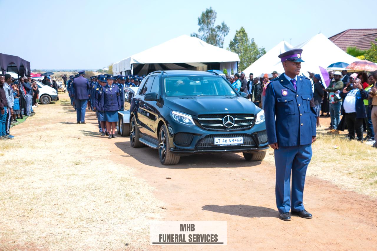 MHB Mercedes-Benz hearse leading a funeral procession with a police guard of honour