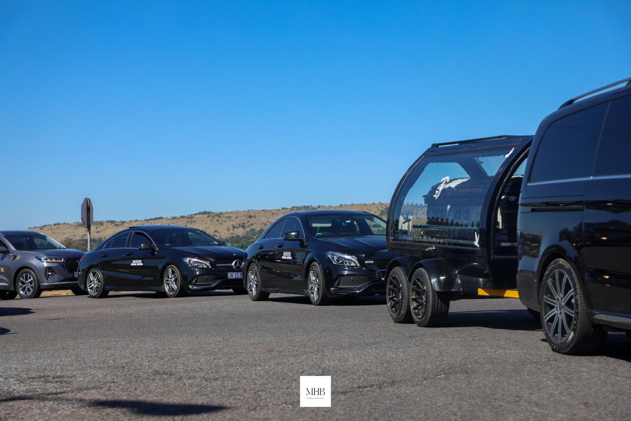 MHB glass carriage hearse and Mercedes-Benz cortege on the road